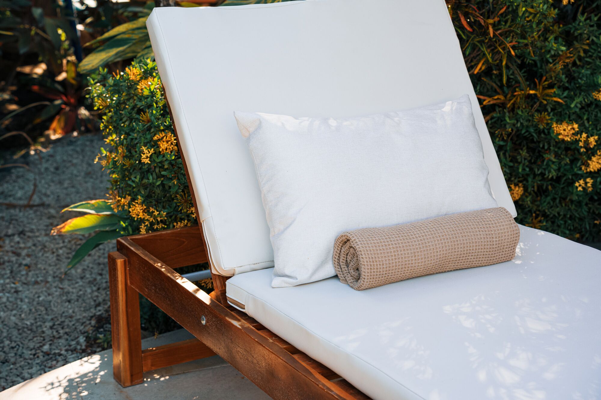 Pool lounger cushion detail with ixora flowers
